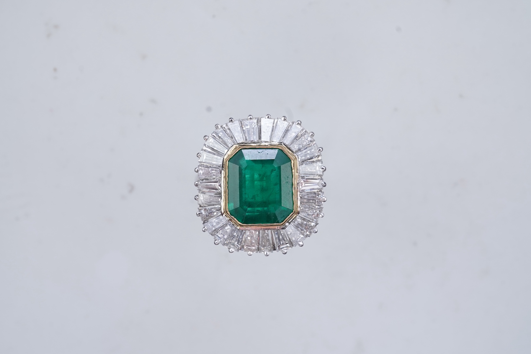 An emerald and diamond ring